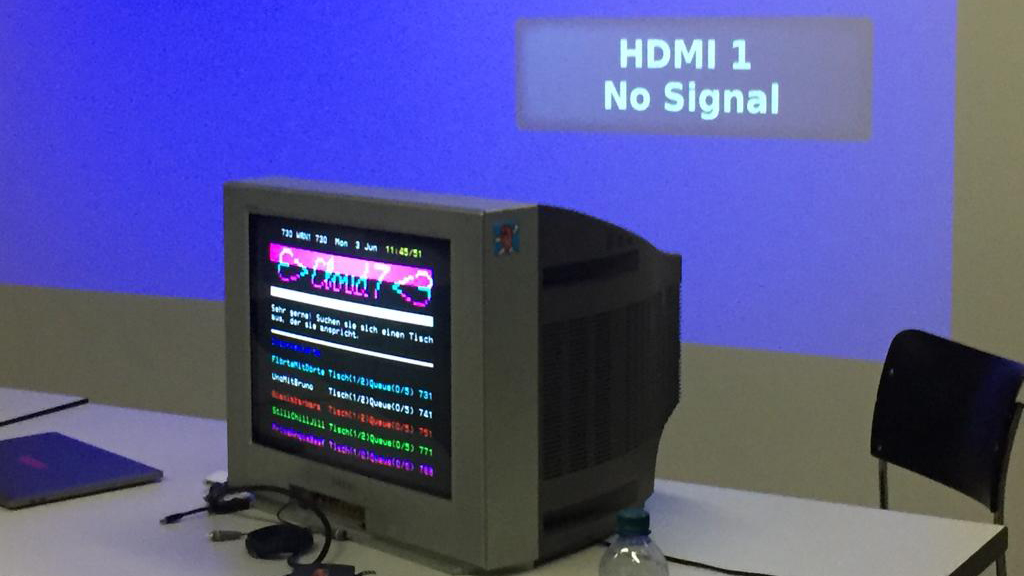 A TV showing a teletext chatroom. The TV is in front of a projector that says 'HDMI1 No Signal'