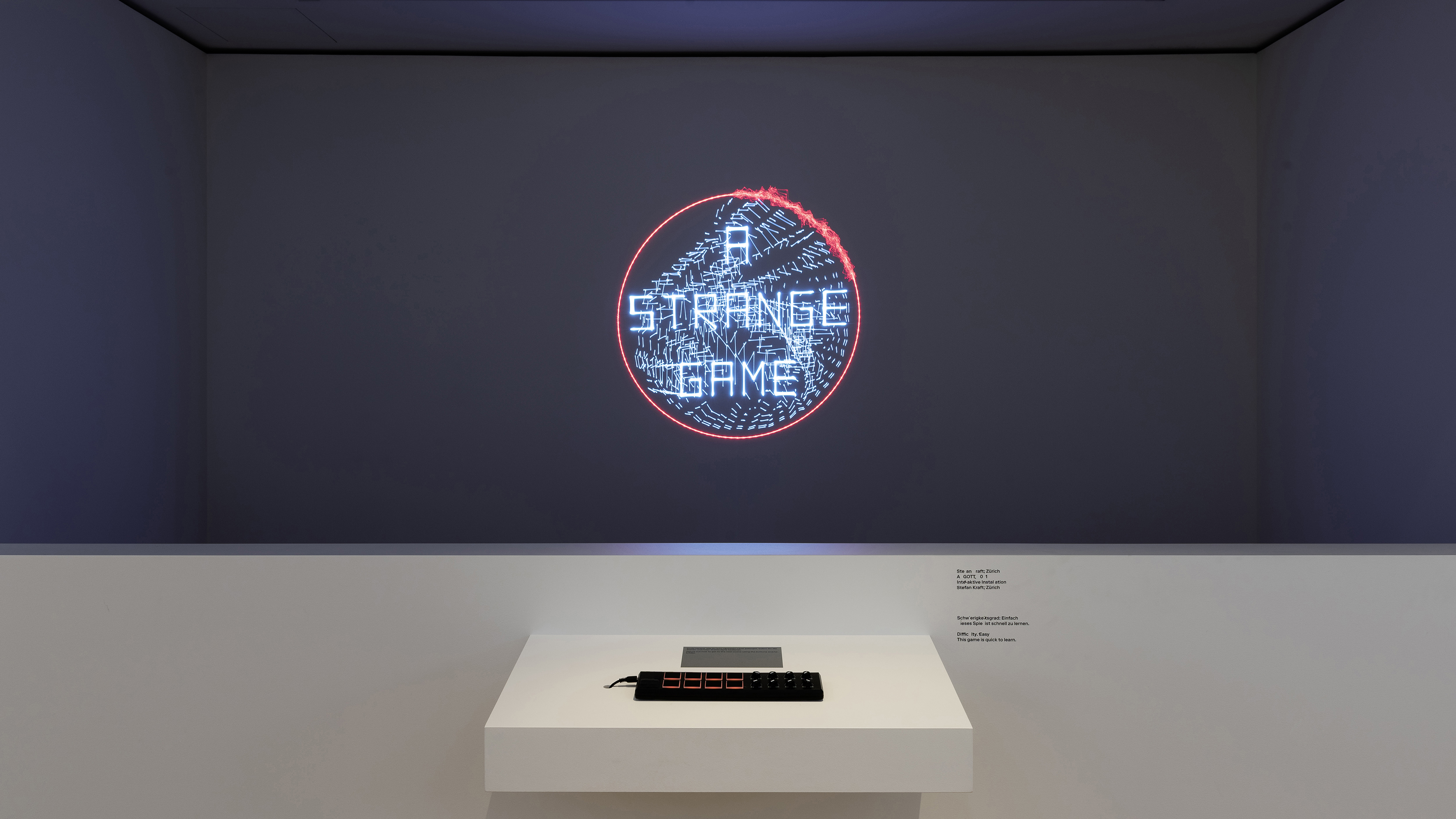 A laser image in an alcove. A red circle, inside the text 'A STRANGE GAME'